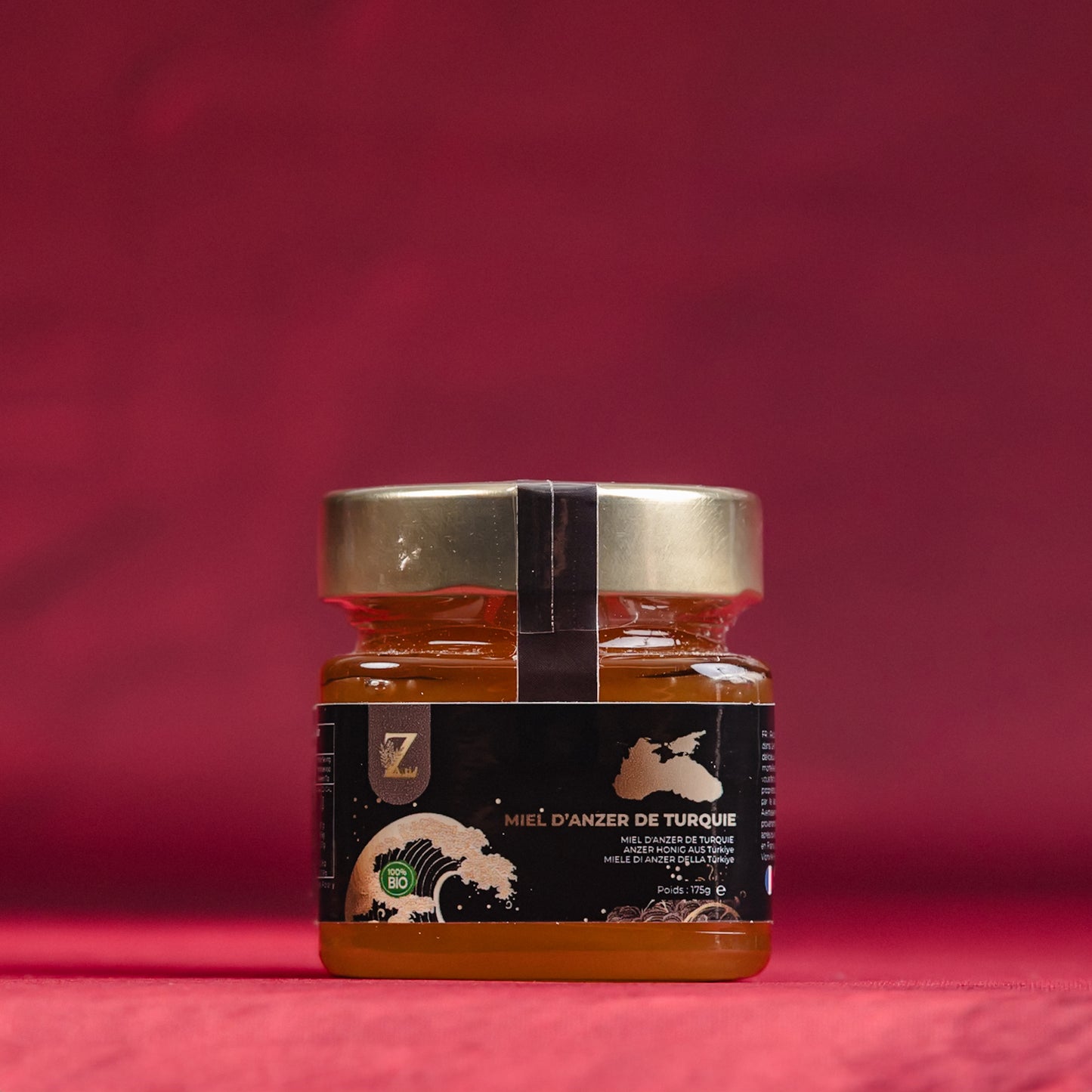 Jar of rare Turkish anzer honey with a black label on a red background