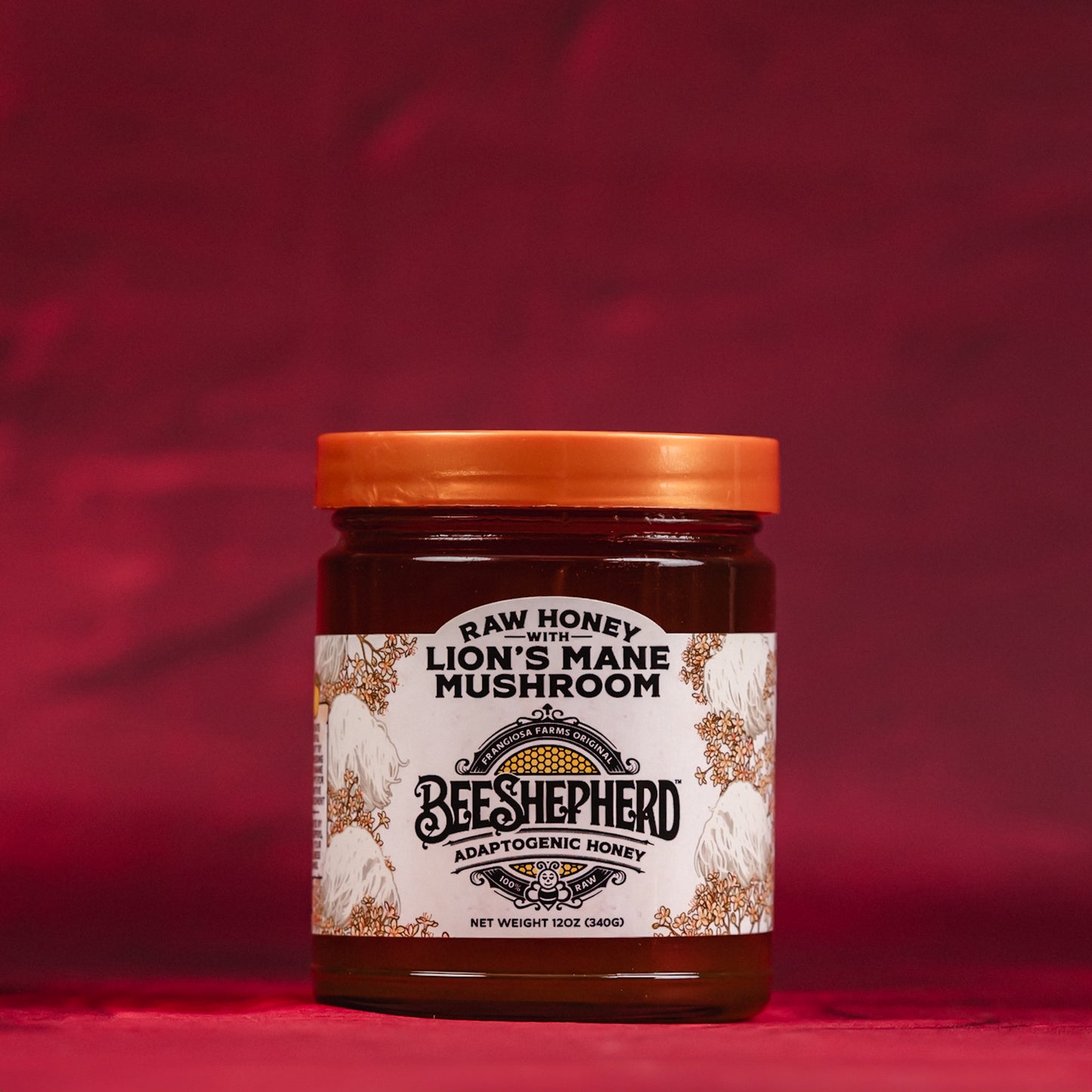 Jar of Beeshepherd Lion's Mane Mushroom honey on a red background