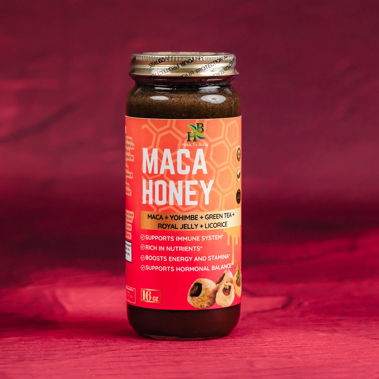 Bottle of maca honey with a red label on a red background